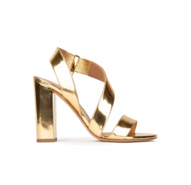 Gold strappy high block heel sandals in mirrored leather Pura López