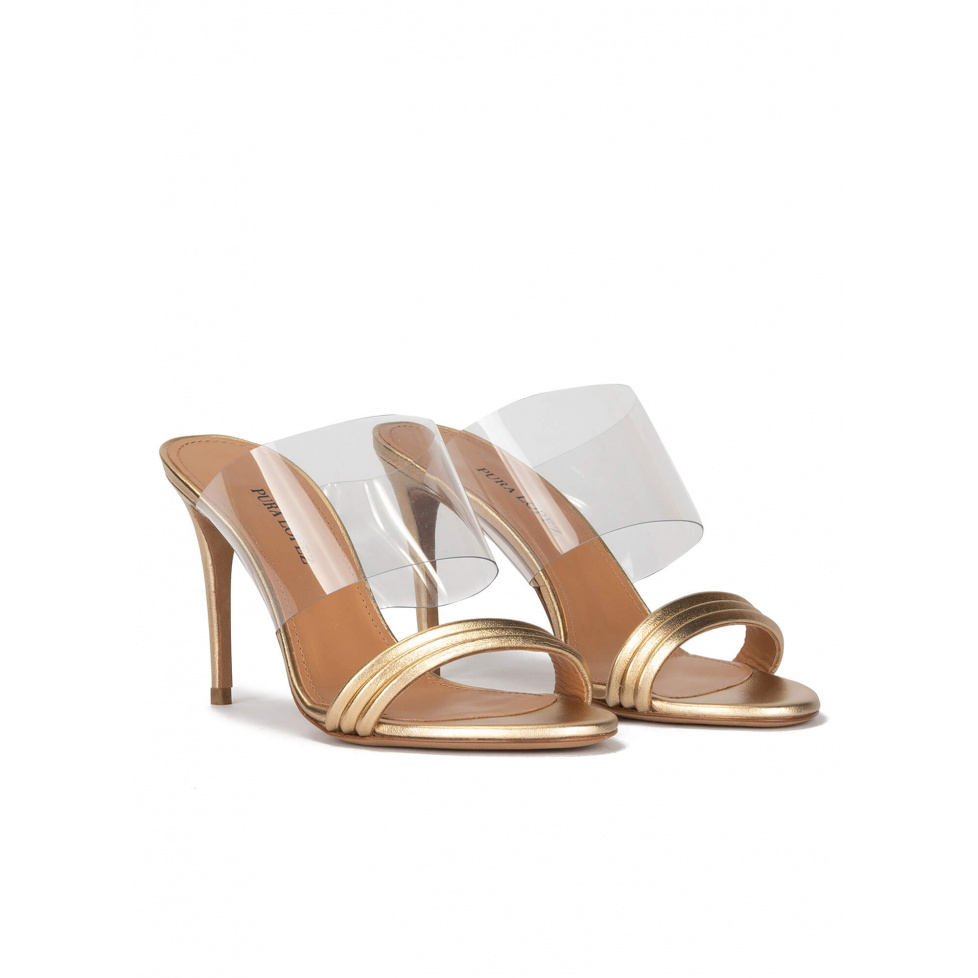 High heel mules in gold leather and transparent vinyl