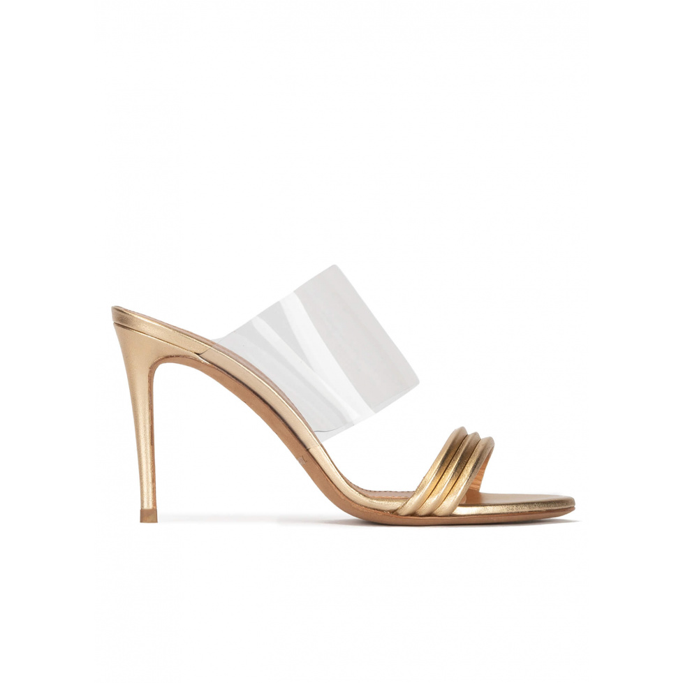 High heel mules in gold leather and transparent vinyl