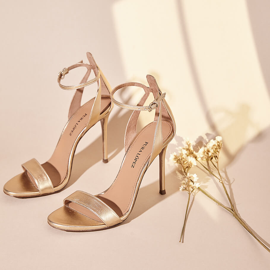 Ankle-strap high heeled sandals in gold metallic leather