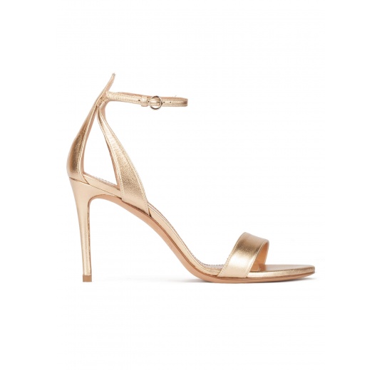 Ankle strap high-heeled sandals in gold leather Pura López