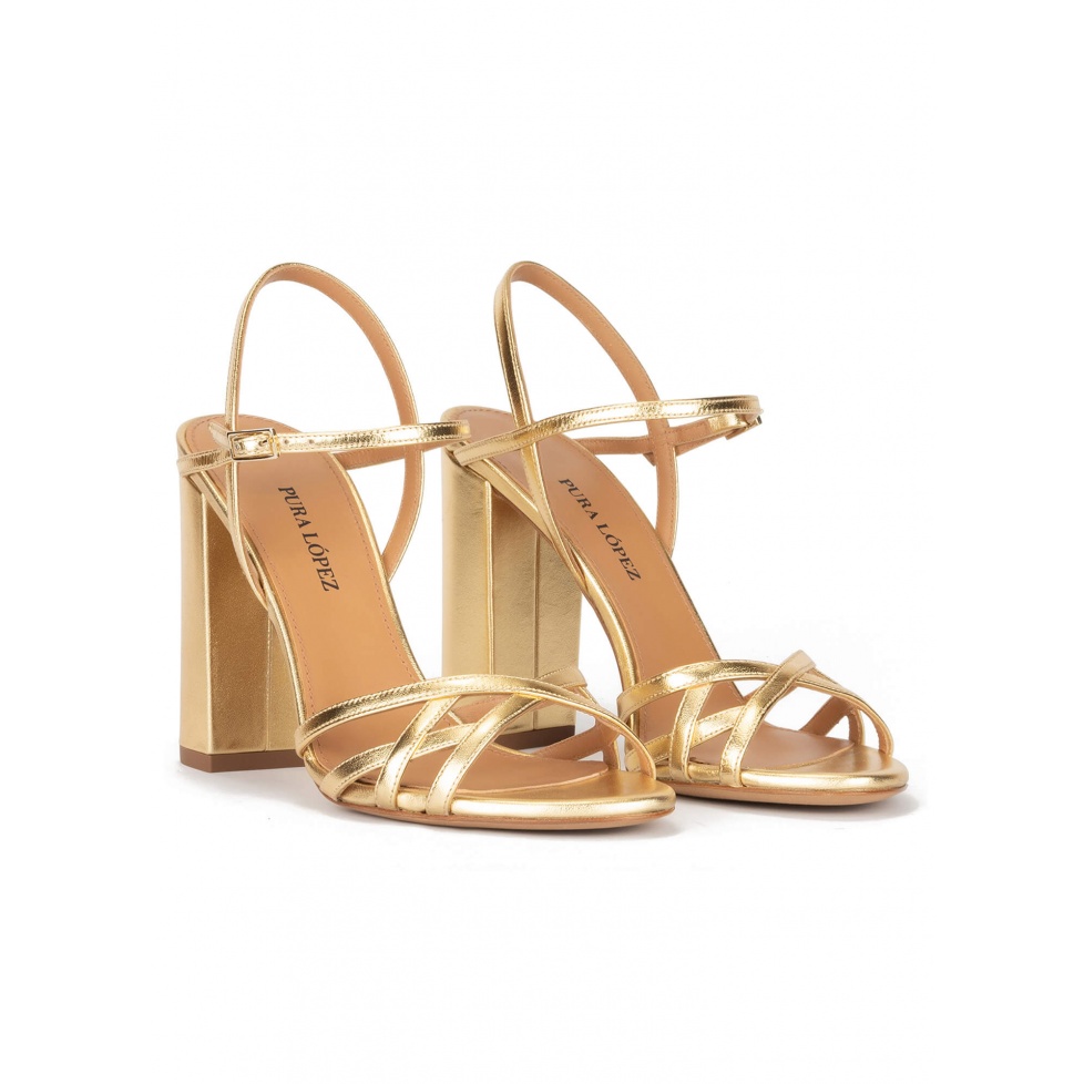 Gold high block heel sandals in metallic leather