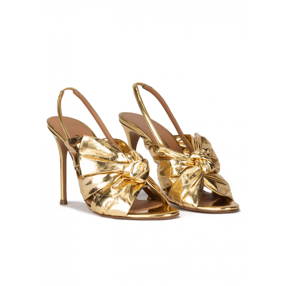 Bow detailed gold high heel sandals in metallic leather