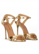 Gold high heel sandals in metallic leather