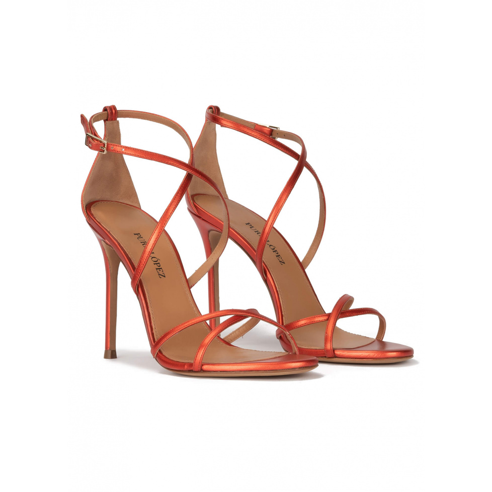 Crossed-strap high heel sandals in coral metallic leather