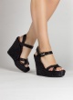 High wedge sandals in black raffia with buckle fastening