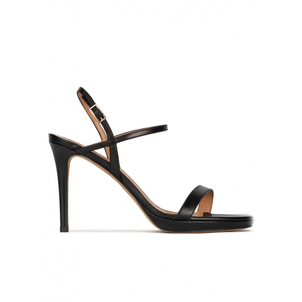 Platform heeled sandals in black leather