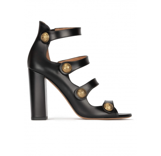 High block heel sandals in black leather with golden buttons Pura López