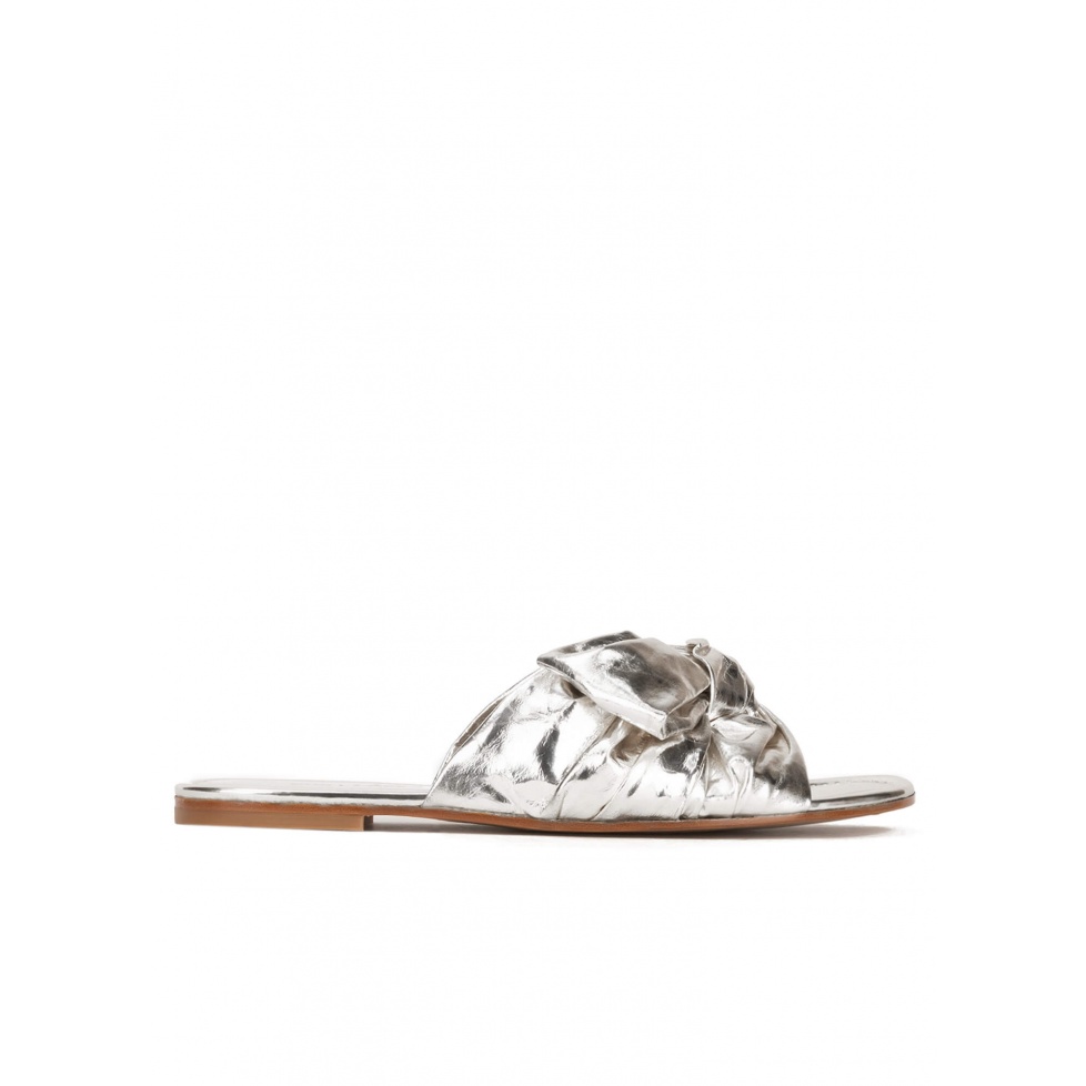 Flat sandals with bow detail made from silver fabric