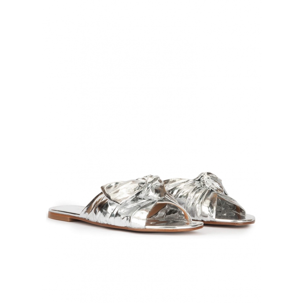 Flat sandals with bow detail made from silver fabric