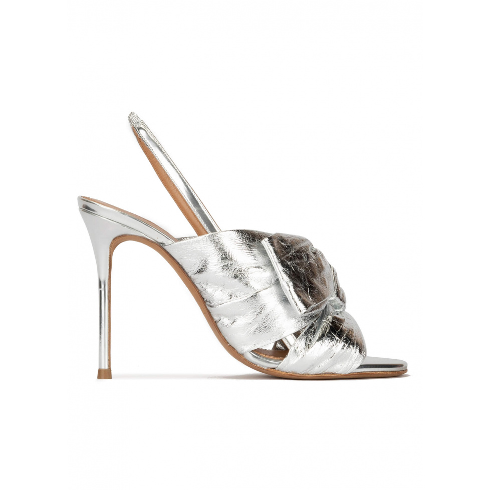 Bow embellished silver high heel sandals in metallic leather