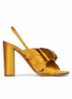 Bow-detailed high block heel sandals in mustard satin